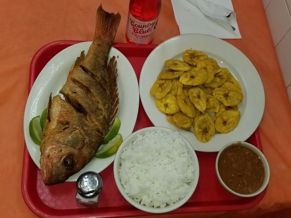 Fried Fish Fried Green Plantains Rice and Beans Red Dominican Soft Drink